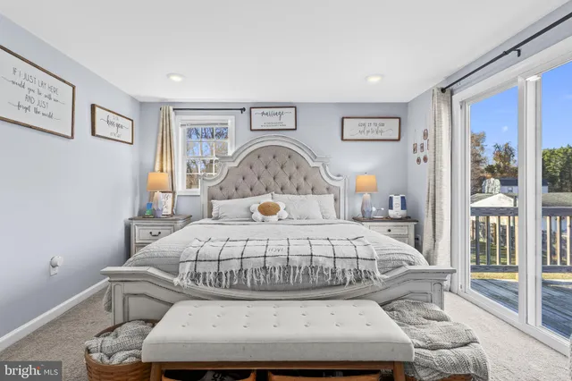 a bedroom with a bed and glass window