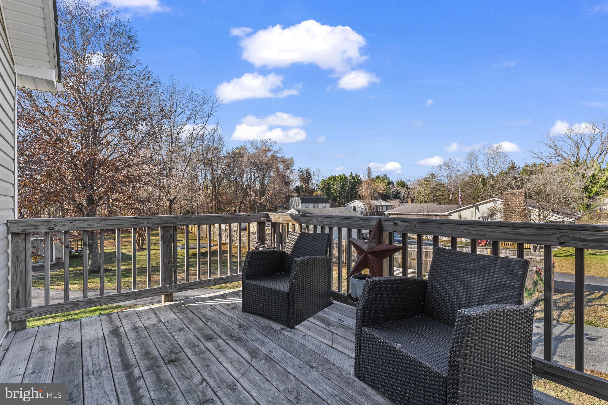 490 Clay Hammond Road Prince Frederick, MD 20678 - Photo 18 of 48 a view of a balcony with wooden floor and iron fence