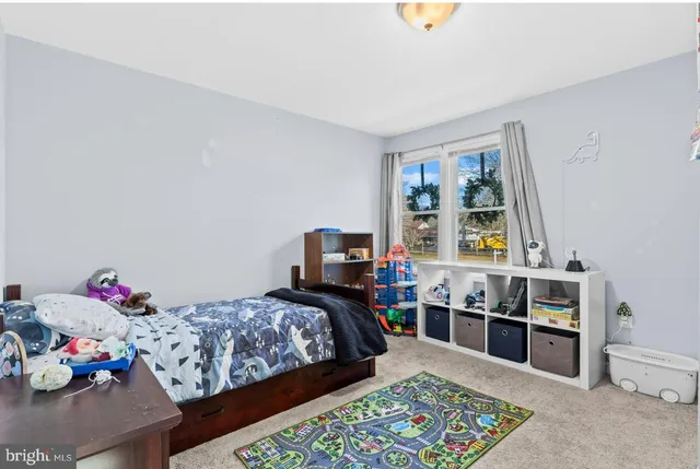 a bed room with a bed and a window