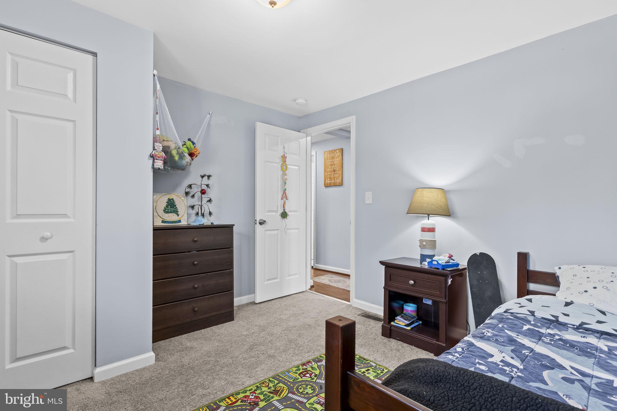 490 Clay Hammond Road Prince Frederick, MD 20678 - Photo 22 of 48 a bedroom with a bed and a dresser in it