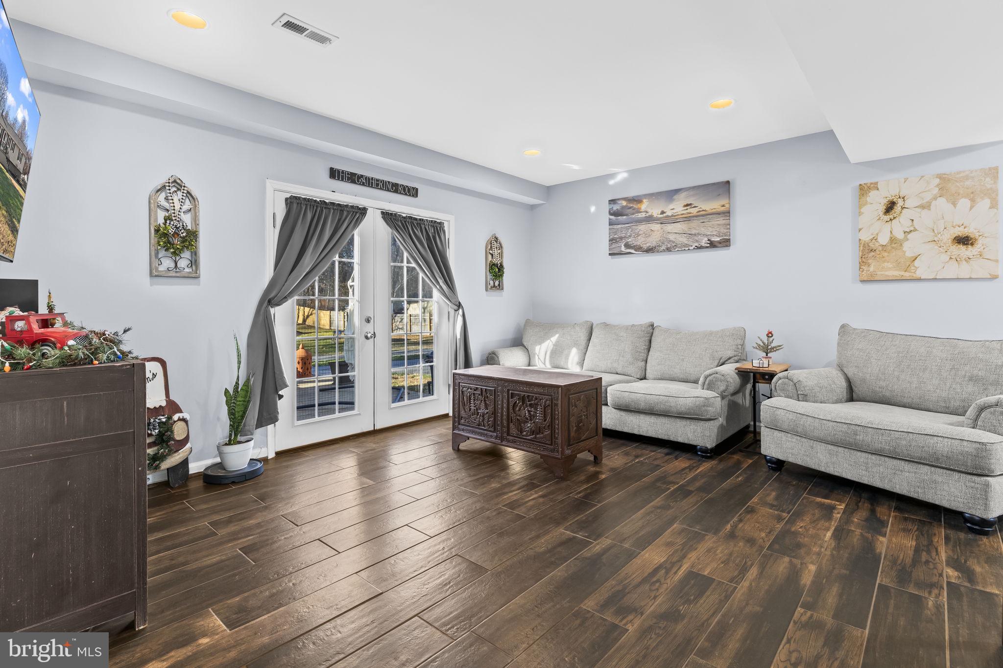 490 Clay Hammond Road Prince Frederick, MD 20678 - Photo 24 of 48 a living room with furniture and a wooden floor