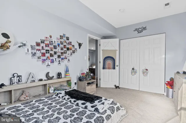 a bedroom with a bed and a dresser