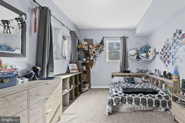 a bedroom with furniture and a large mirror