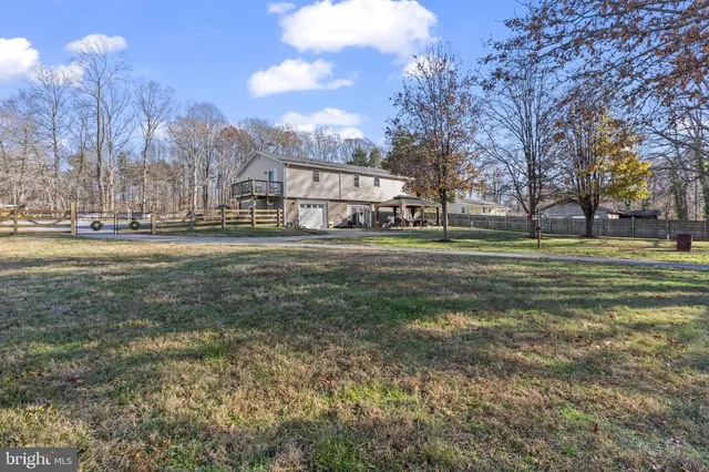 a view of a big yard with a house in the background