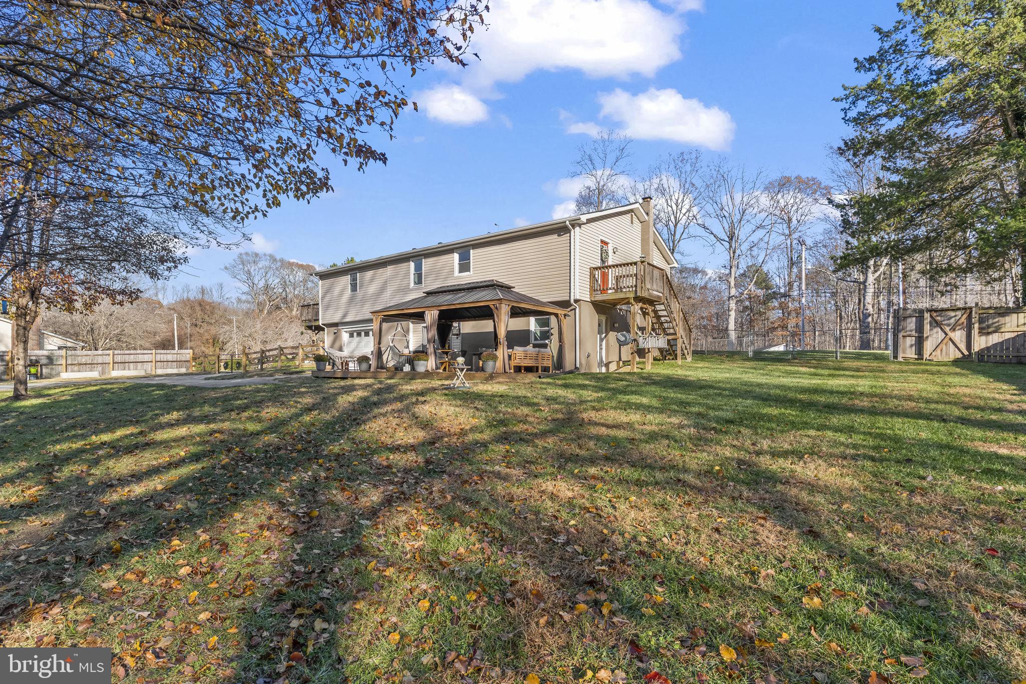 490 Clay Hammond Road Prince Frederick, MD 20678 - Photo 38 of 48 a view of a white house with a big yard and large trees