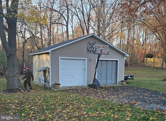 a front view of house with backyard and trees