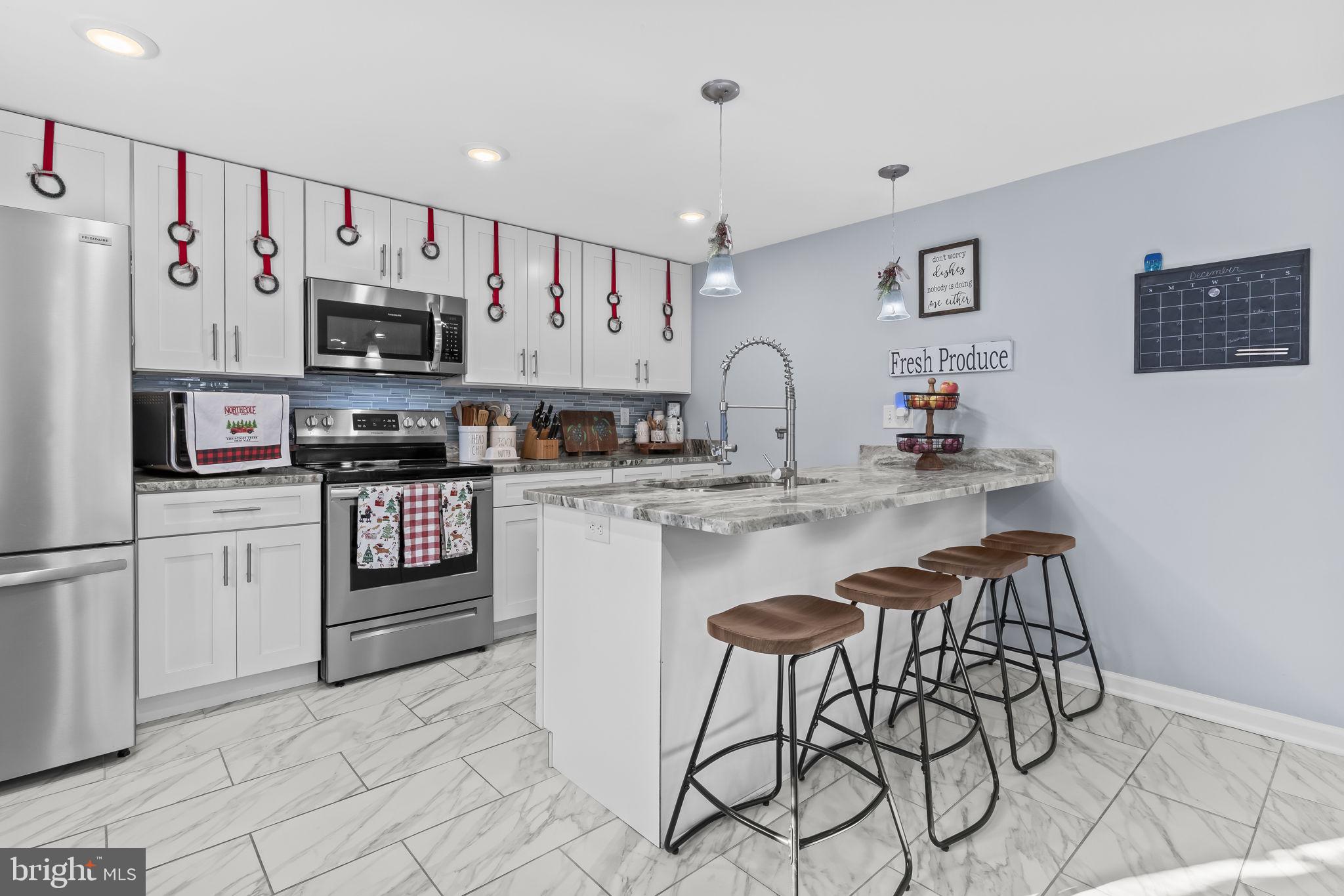 490 Clay Hammond Road Prince Frederick, MD 20678 - Photo 5 of 48 a kitchen with stainless steel appliances a refrigerator sink and white cabinets