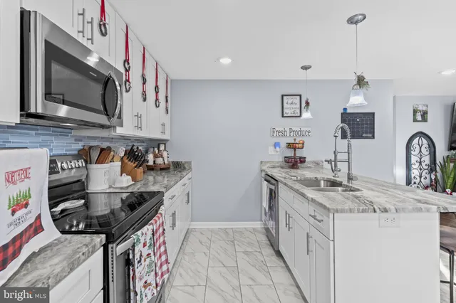 a kitchen that has a sink and a stove in it