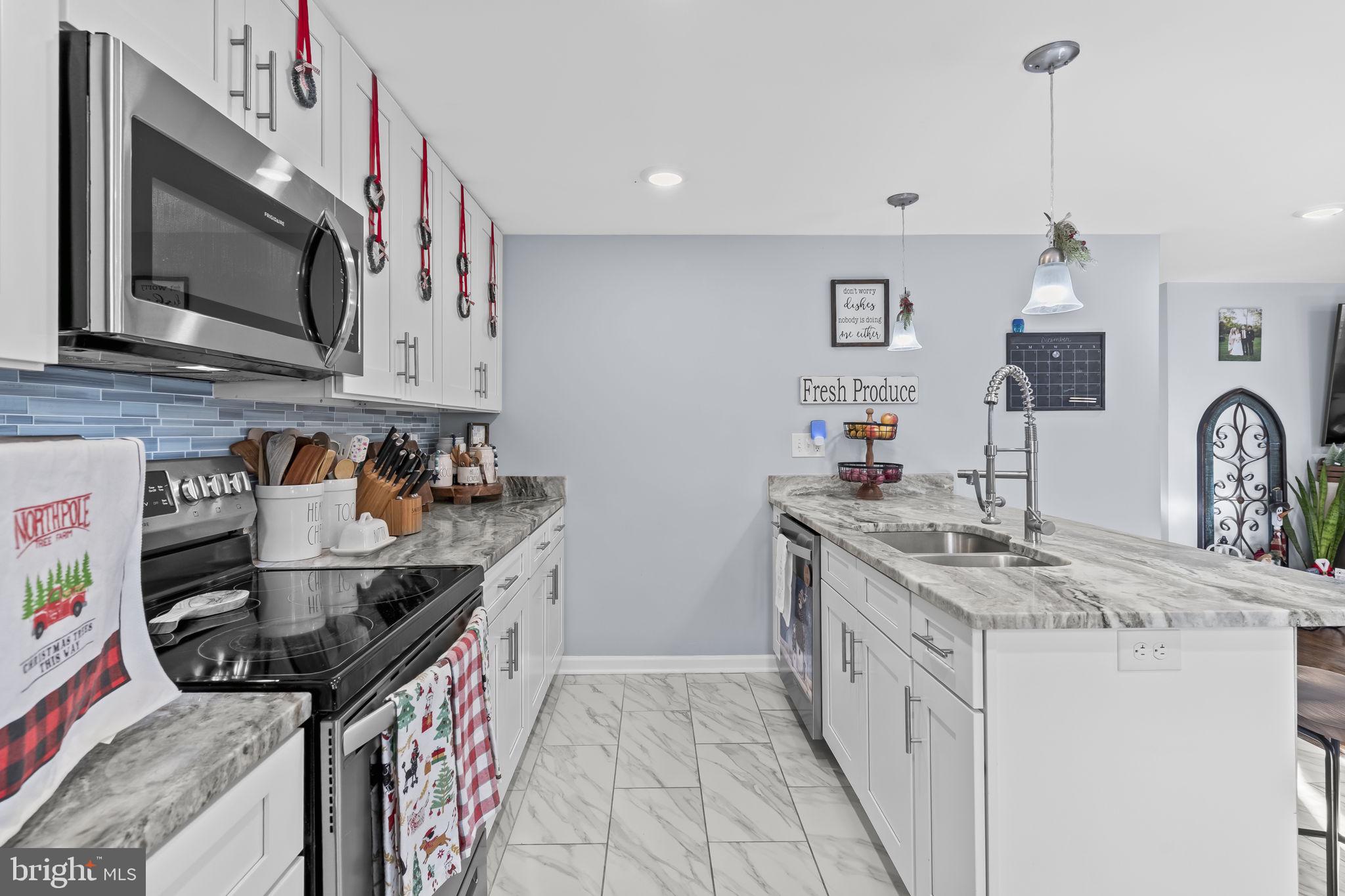 490 Clay Hammond Road Prince Frederick, MD 20678 - Photo 6 of 48 a kitchen that has a sink and a stove in it