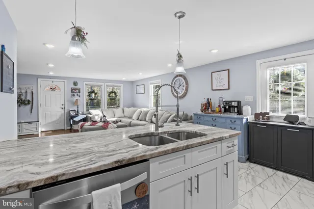 a view of a kitchen counter space a sink and wooden floor