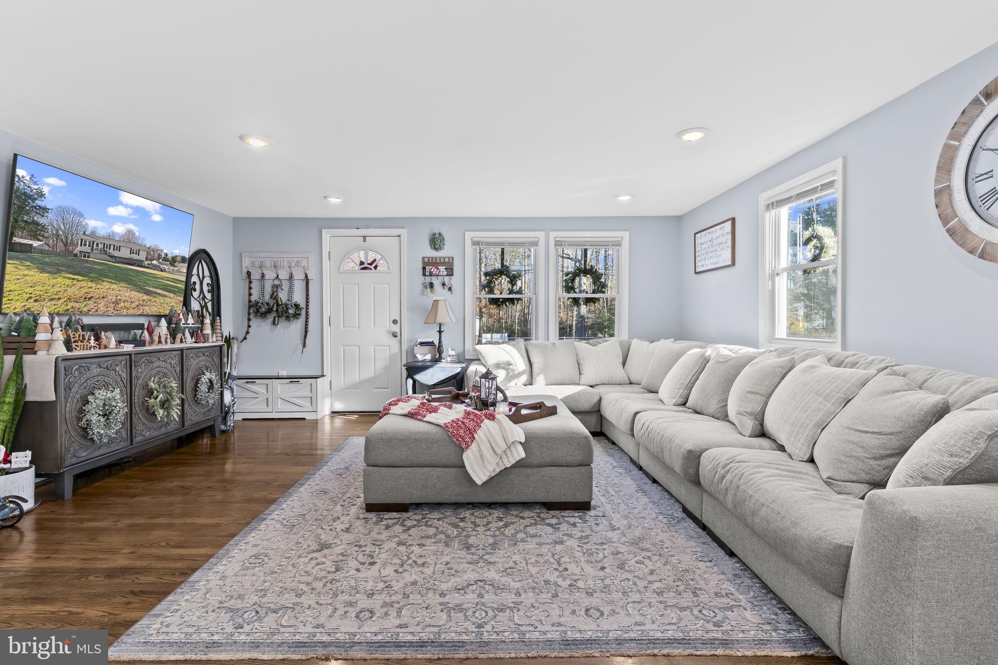 490 Clay Hammond Road Prince Frederick, MD 20678 - Photo 8 of 48 a living room with furniture and a flat screen tv