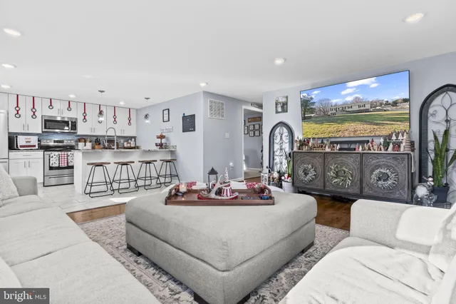 a living room with furniture and a floor to ceiling window