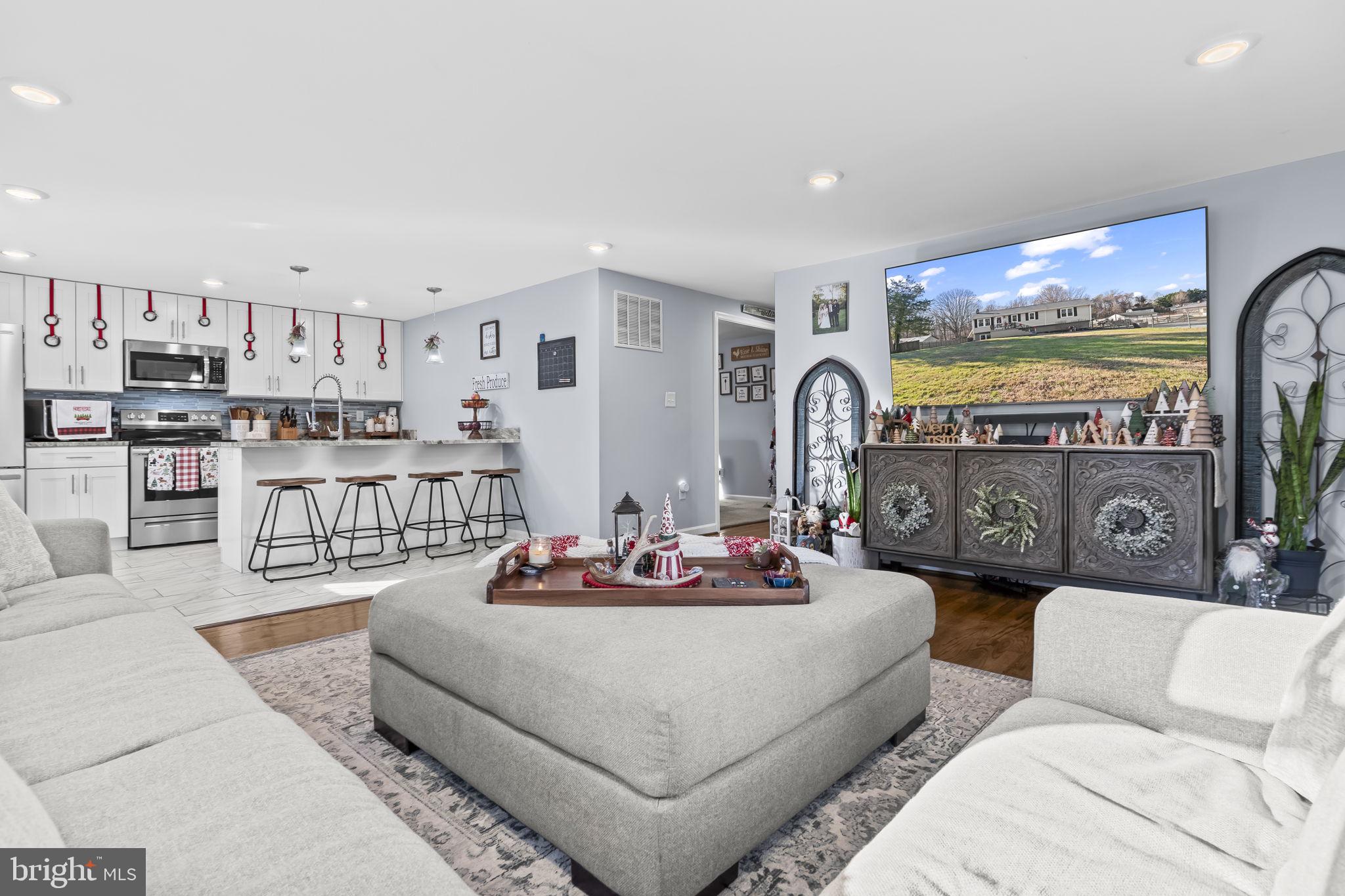 490 Clay Hammond Road Prince Frederick, MD 20678 - Photo 10 of 48 a living room with furniture and a floor to ceiling window