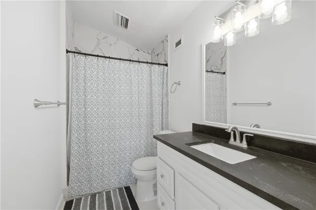 a spacious bedroom with a bed and a large window