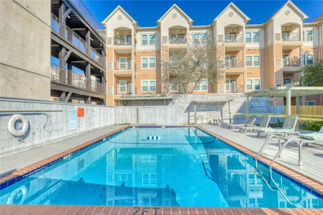 a aerial view of a house with a yard and balcony