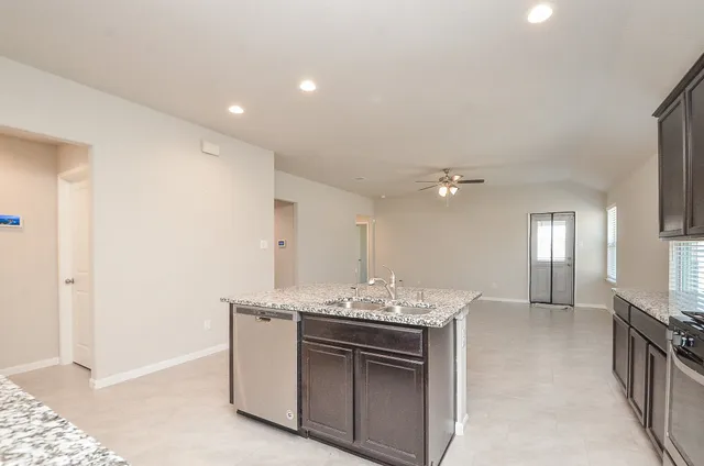 a spacious bathroom with a granite countertop sink and a mirror