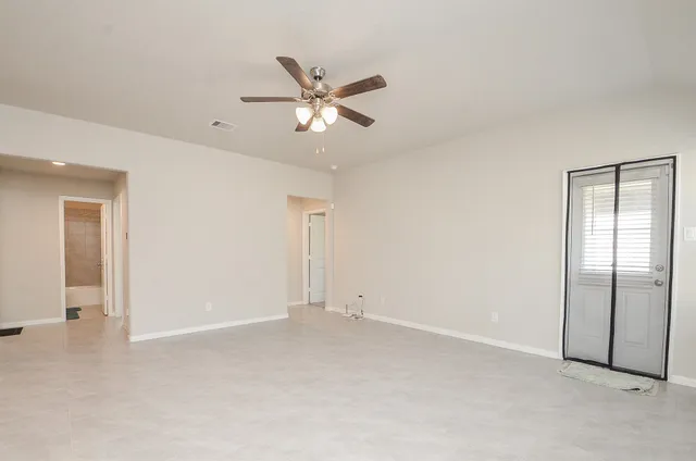 a view of a living room kitchen with a sink and a window