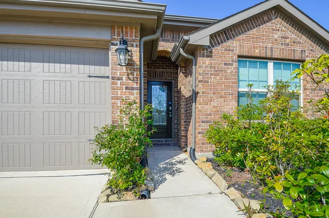 a view of a house with potted plants