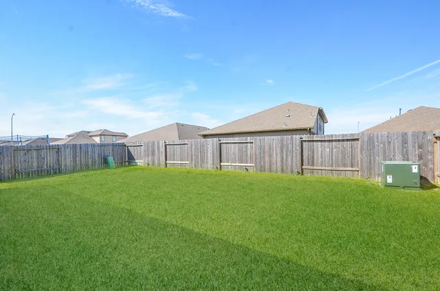 a view of a house with a yard and a porch