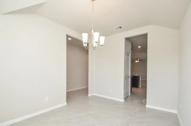 a view of a chandelier in big room and chandelier