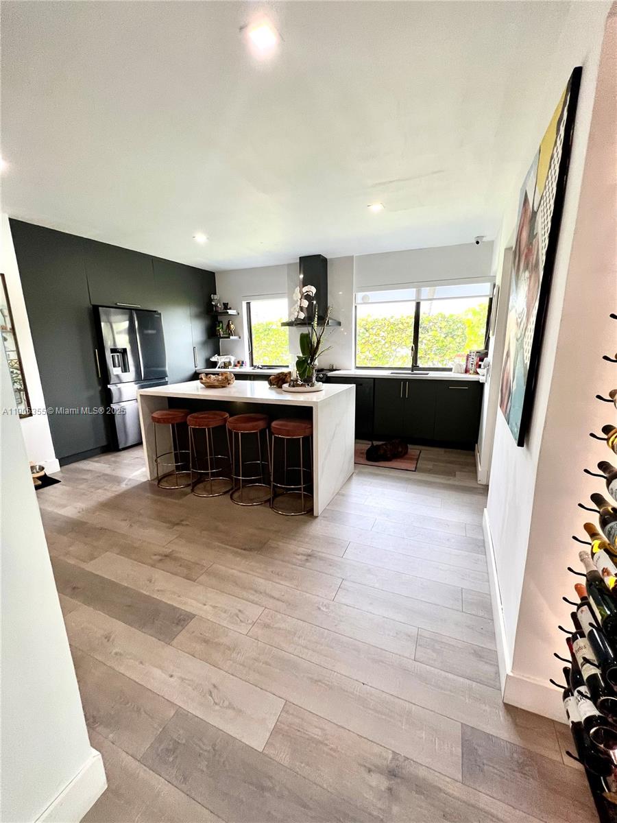 1051 Northwest 25th Avenue Miami, FL 33125 - Photo 5 of 7 a view of a livingroom with furniture window and wooden floor
