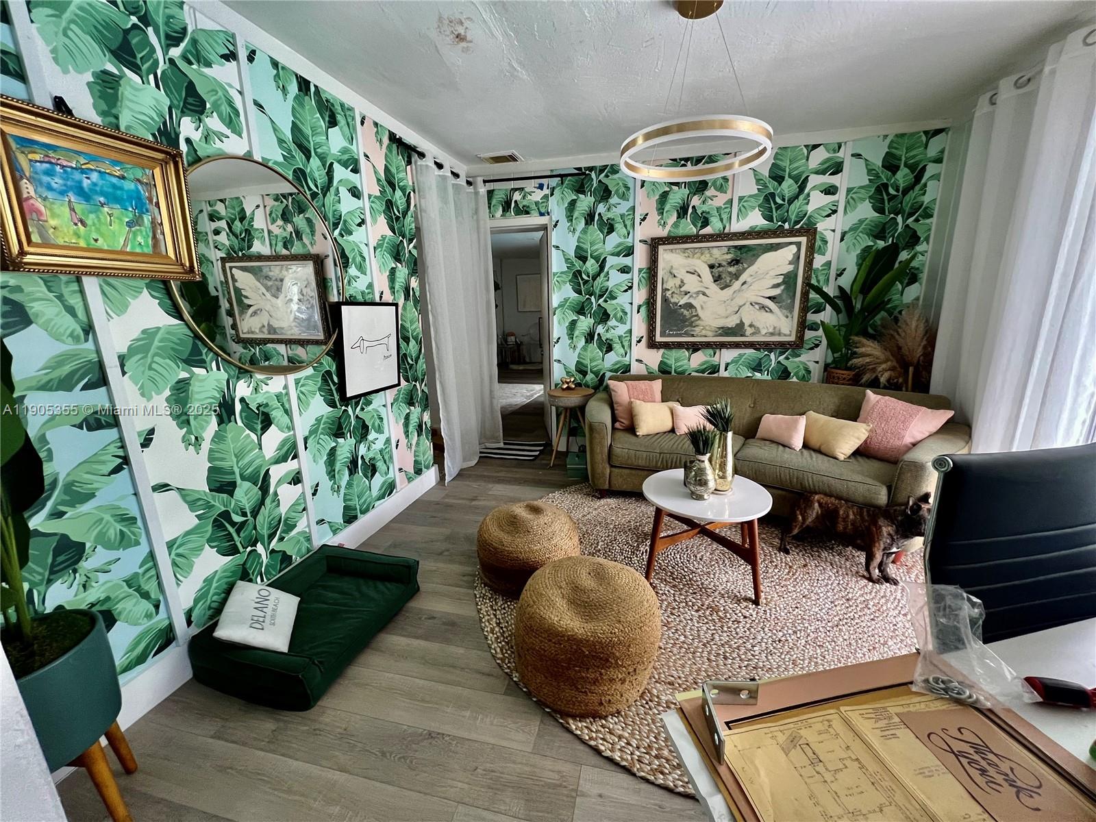 1051 Northwest 25th Avenue Miami, FL 33125 - Photo 7 of 7 a living room with patio furniture and a potted plant