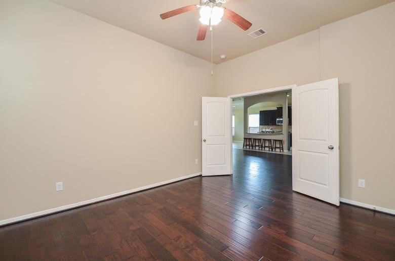 4327 Estes Ridge Lane Katy, TX 77493 - Photo 22 of 37 wooden floor in an empty room with a window