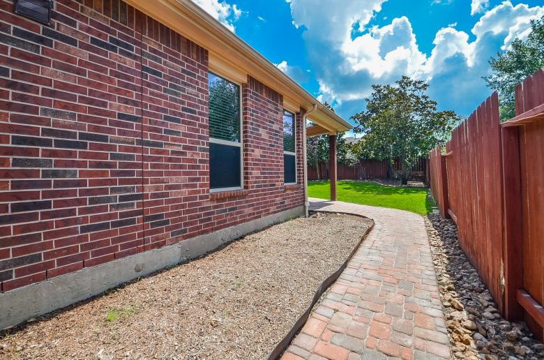 4327 Estes Ridge Lane Katy, TX 77493 - Photo 31 of 37 a view of brick house with a yard