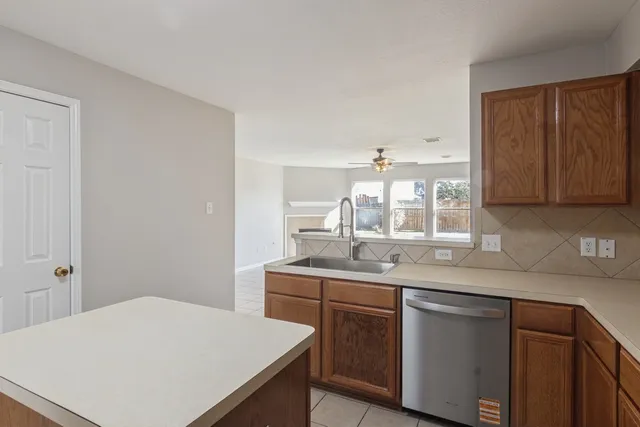 a kitchen with a sink and cabinets