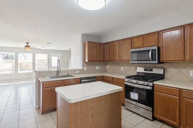 a kitchen with a sink stove and microwave