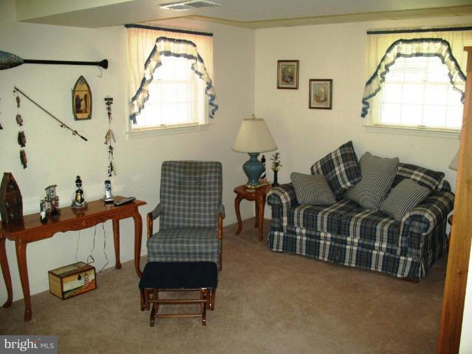 3615 Pine Tree Road Port Republic, MD 20676 - Photo 14 of 16 a living room with furniture rug and a window