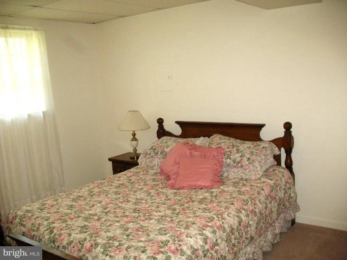 3615 Pine Tree Road Port Republic, MD 20676 - Photo 6 of 16 a bedroom with a bed and wooden floor