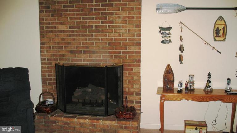 3615 Pine Tree Road Port Republic, MD 20676 - Photo 8 of 16 a living room with a fireplace and a fireplace