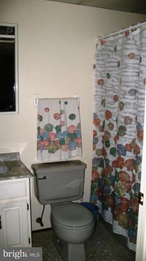 3615 Pine Tree Road Port Republic, MD 20676 - Photo 10 of 16 a white toilet sitting next to a shower curtain