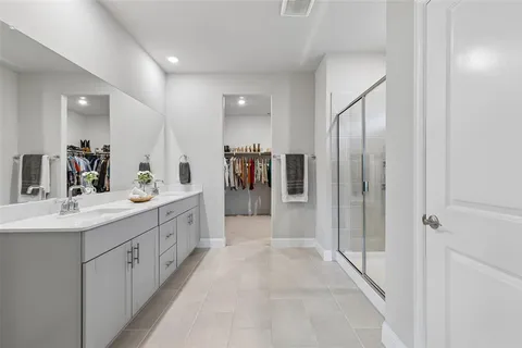 a bathroom with a double vanity sink and a mirror