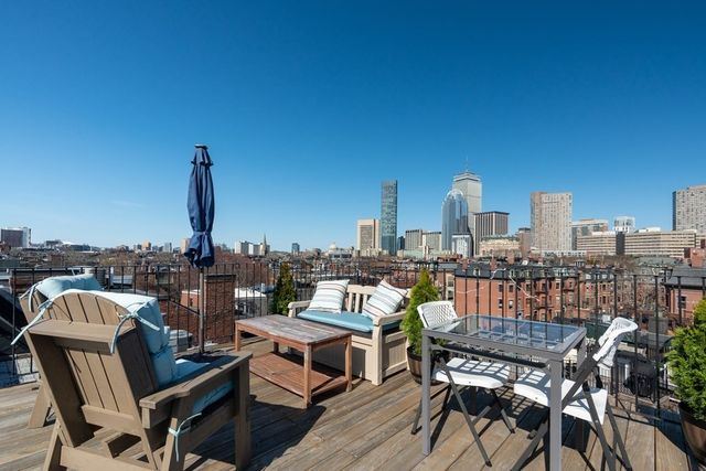 a view of a balcony with two chairs and a table