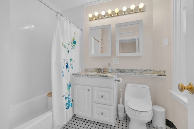 a living room with furniture and a baby crib