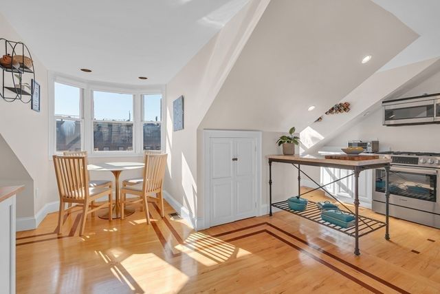 a bedroom with furniture and a large window