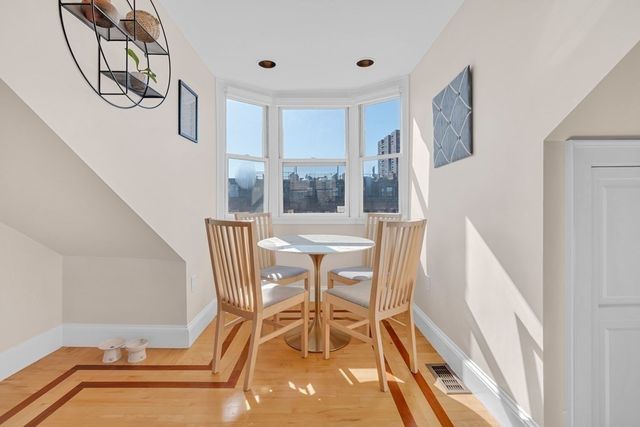 a view of a dining room with furniture and a floor to ceiling window