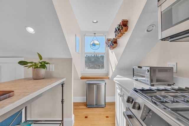 a kitchen with a stove and a white cabinet