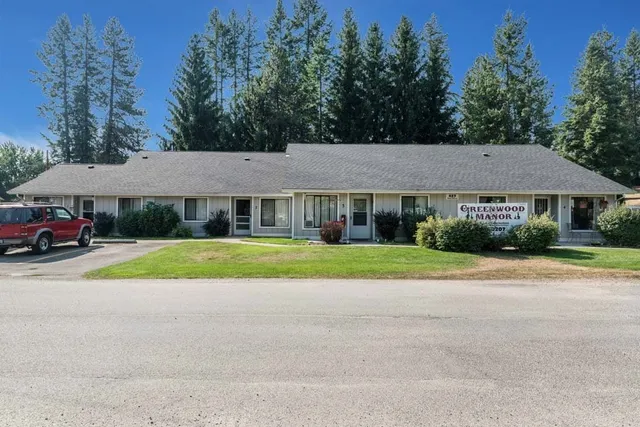 a view of house with yard and outdoor seating