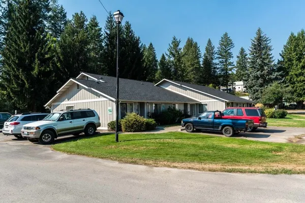 a car parked in front of a house and a yard