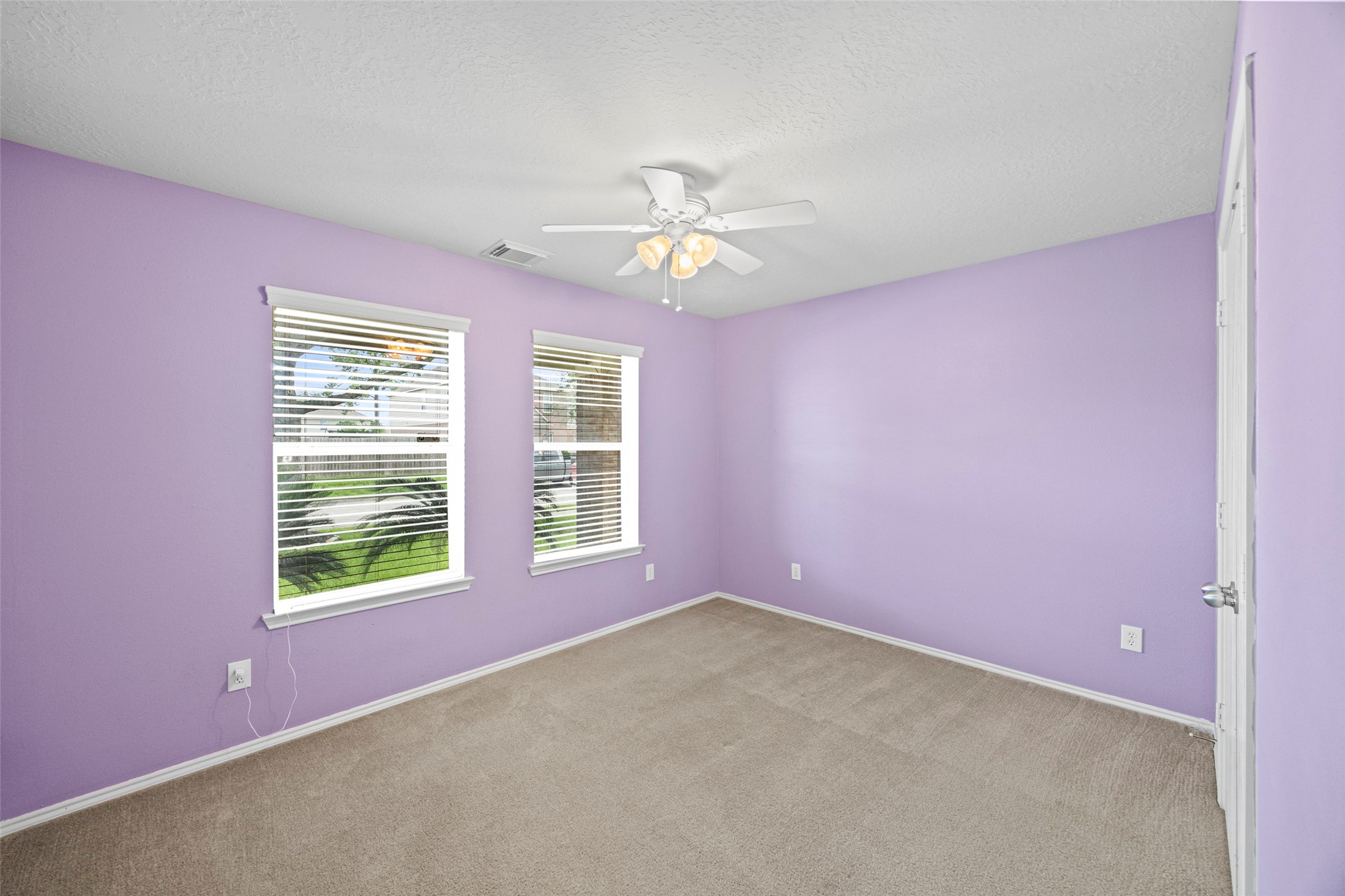 9510 Barr Spring Drive Humble, TX 77396 - Photo 16 of 27 an empty room with a window and a fan