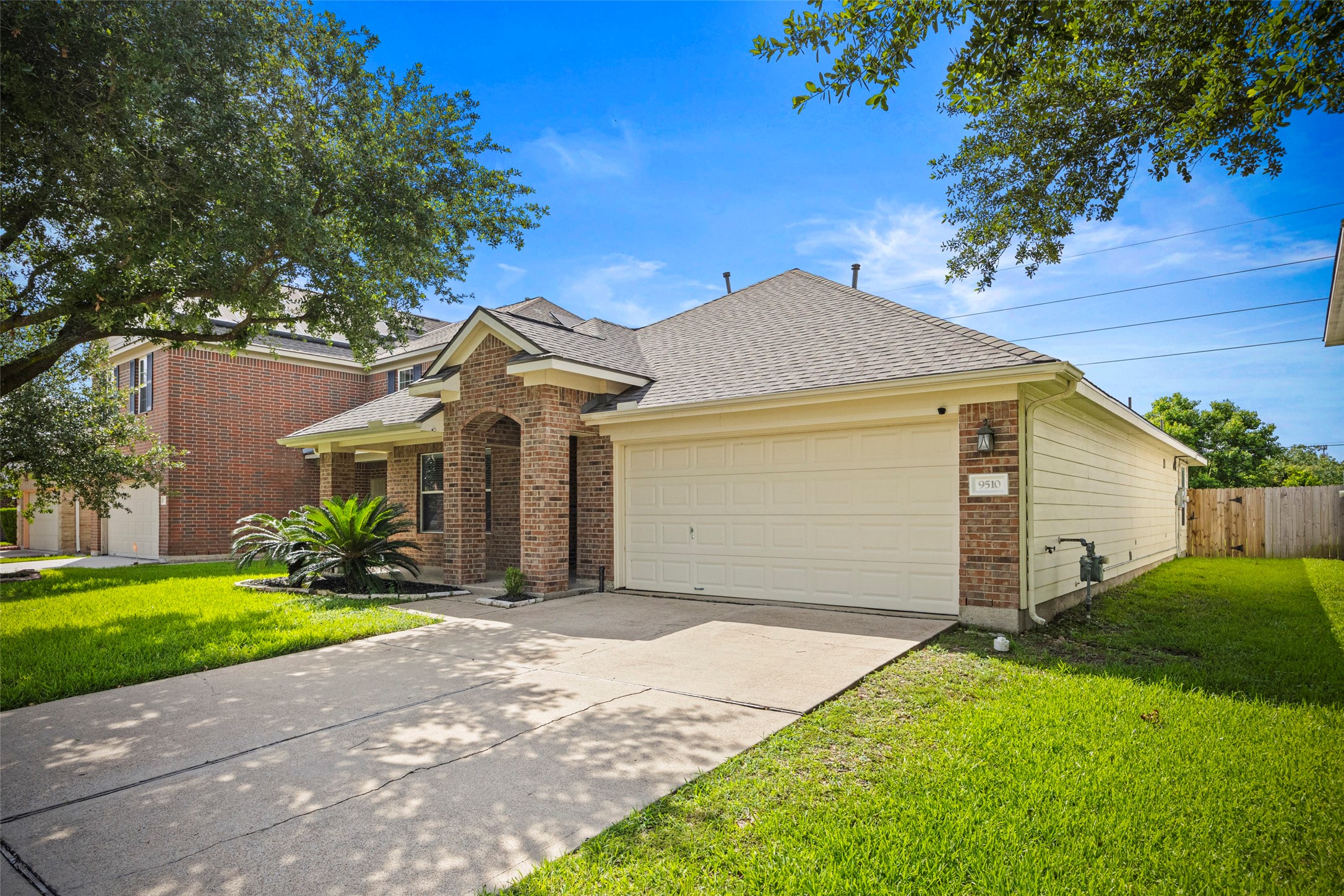 9510 Barr Spring Drive Humble, TX 77396 - Photo 2 of 27 a view of a house with a yard and large tree