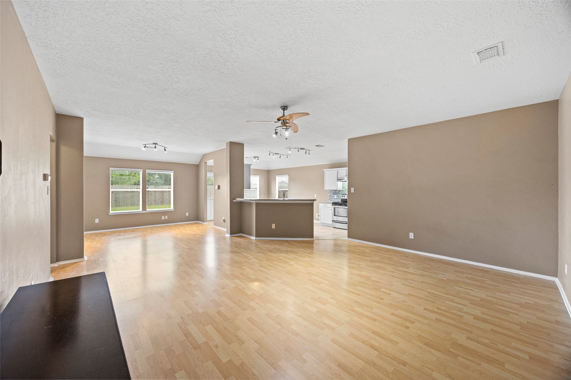 9510 Barr Spring Drive Humble, TX 77396 - Photo 8 of 27 a view of an empty room with window and wooden floor