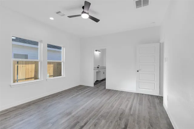 a bathroom with a granite countertop sink and a bathtub