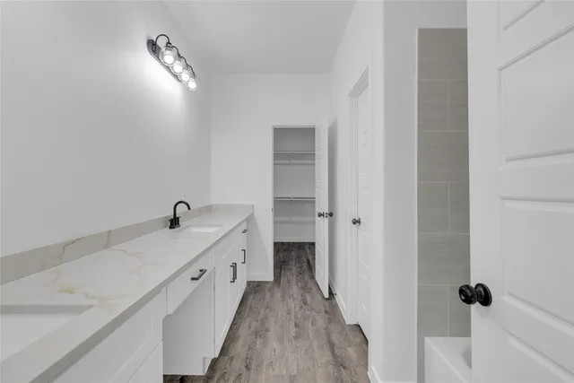 a bathroom with a double vanity sink and mirror
