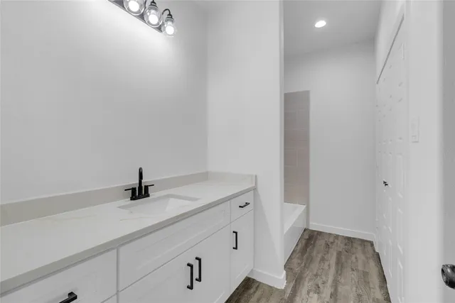 a bathroom with a sink and shower