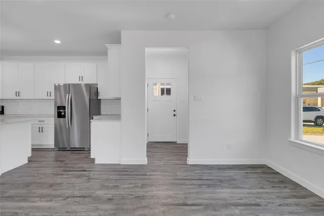 a view of kitchen with refrigerator and window