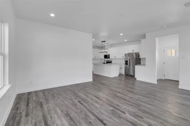 a view of a kitchen with a sink and a refrigerator